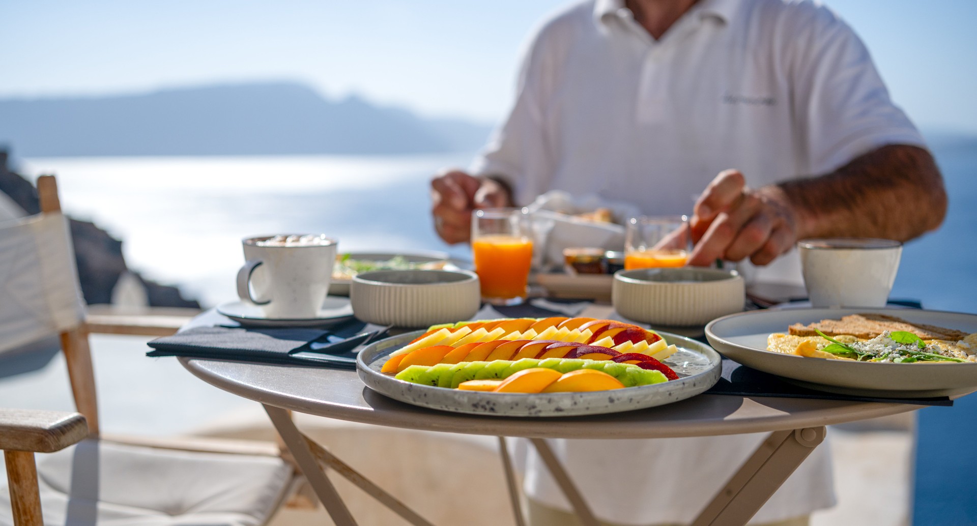 Breakfast being served at a table at a luxury hotel or restaurant in Santorini