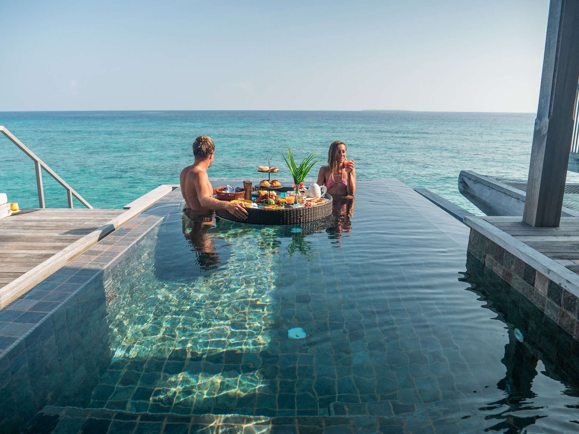 Couple enjoying floating breakfast in luxury hotel